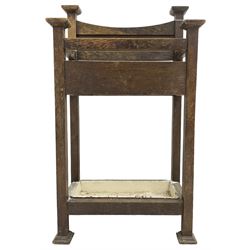 Early 20th century Arts & Crafts oak stick stand, panelled back over three divisions, fitted with metal drip tray, on square supports