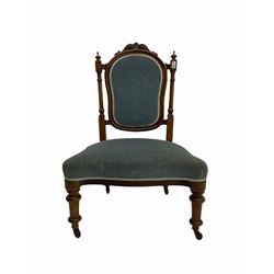 Victorian walnut nursing chair, the cresting rail carved with scrolled foliage, turned supports