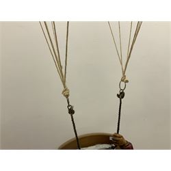 Painted wooden hanging model of a hot air balloon group, the balloon above a wicker basket complete with sandbags and figures, together with a similar example with a clown figure below, H68cm