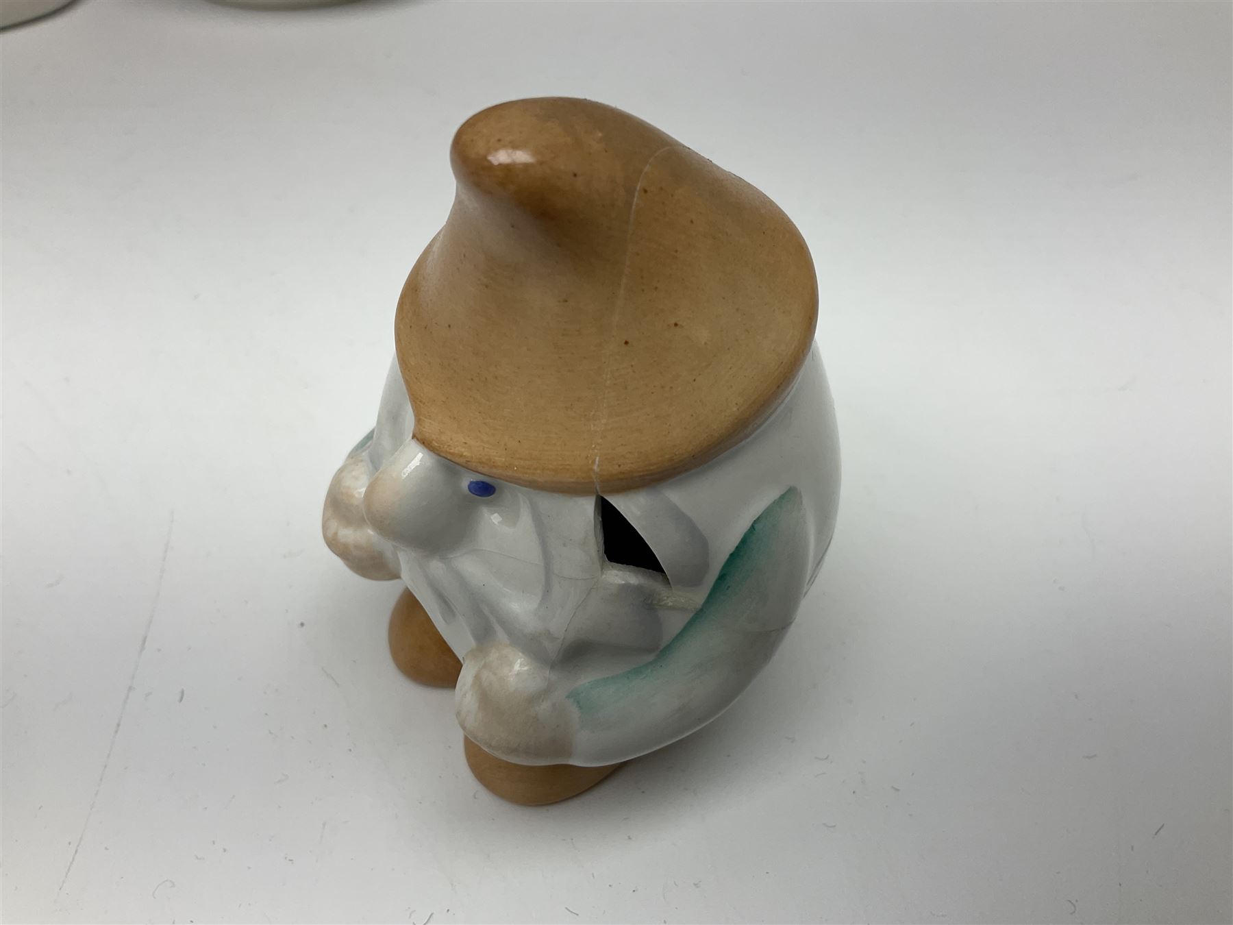 Group of eleven Aquincum of Budapest figures, comprising two of a man in a feather hat, seven dwarves, man and woman in traditional dress, all with printed marks beneath