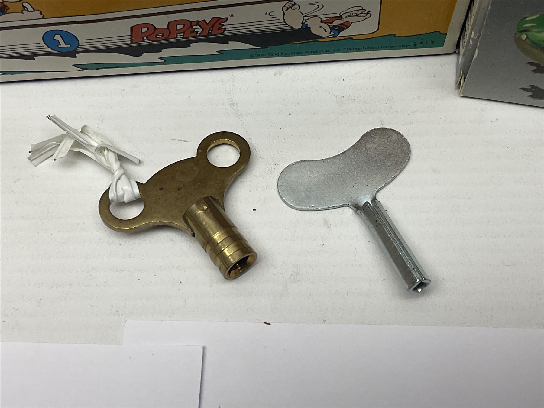 Twenty six tinplate models to include Ferris Wheel and Performing Circus Elephant, marked JW, further similar examples such as Duck on a Bike, Clown on Roller, Carousel; Popeye Tin Speedboat; Looney Tunes Wind Up Cars and Express Train; various international examples, MS107 Jumping Bambi, Pop Pop Boat, jumping frogs, pecking chickens etc; both boxed and loose