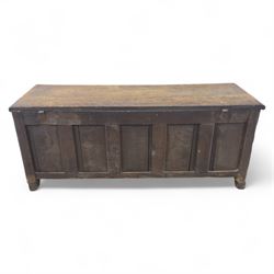18th century oak five panel chest, with planked top with chamfered edges, hinged top enclosing two candle boxes, five fielded panels flanked by foliate carvings, raised on stile supports