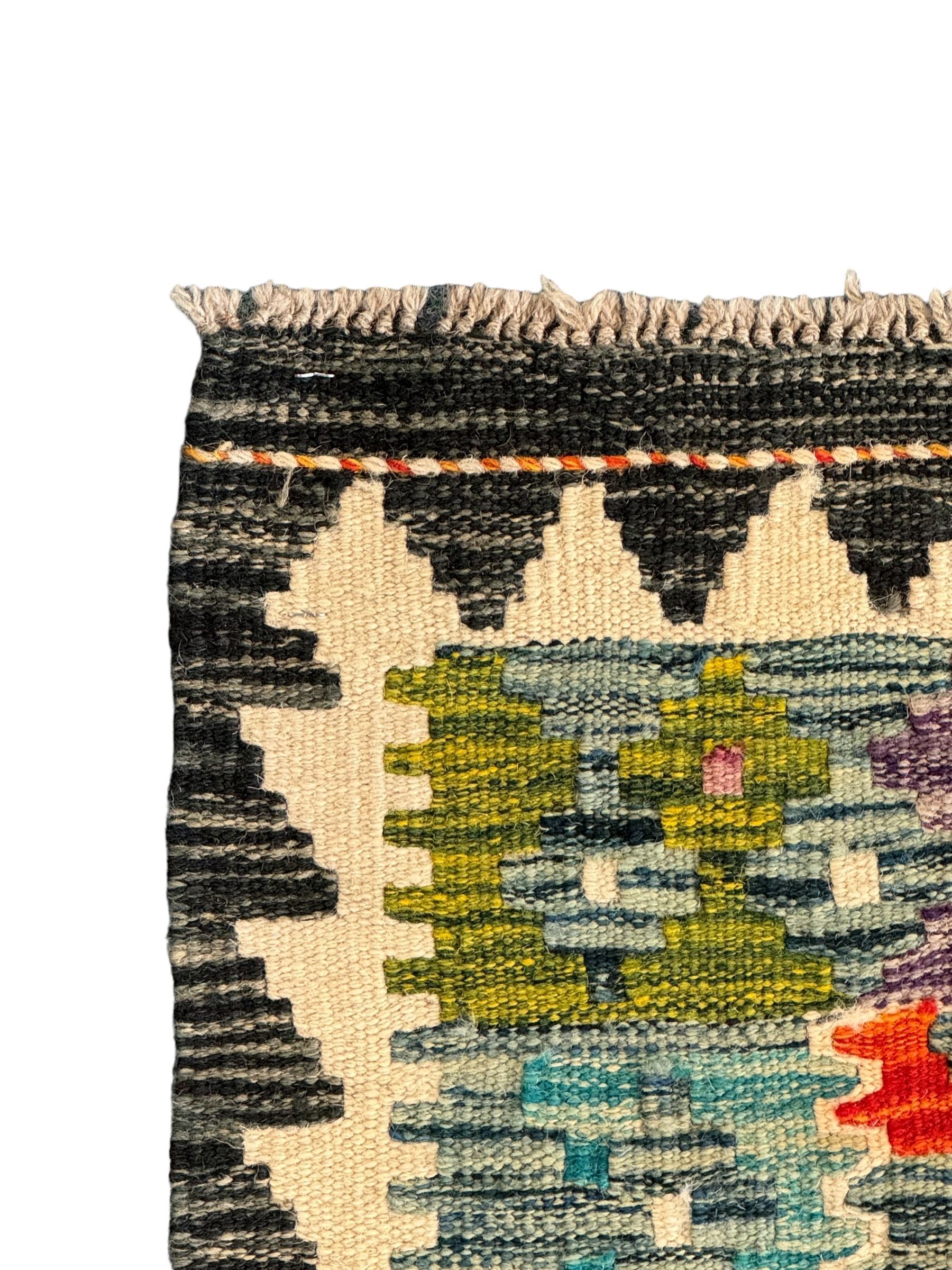 Chobi kilim multi-colour ground runner, the field decorated with lozenges and geometric patterns, within hooked border 