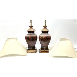 Pair Oriental table lamps decorated with birds in a tree with fruit, on a red ground with a gilded base together with cream lampshades H57cm, without lampshade. 