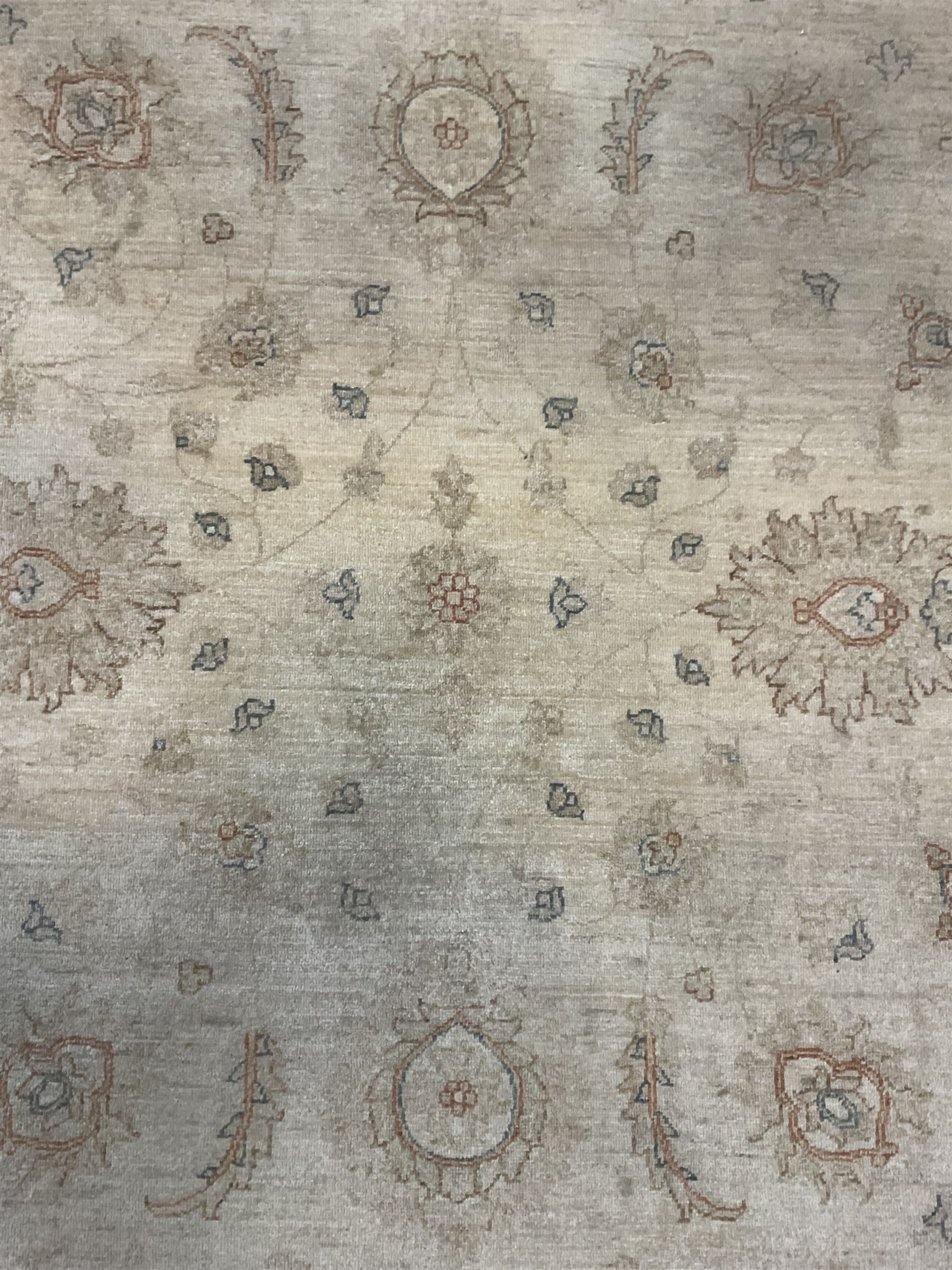 Persian Zeigler rug, ivory ground and decorated with stylised plant motifs, floral design border