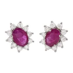 Pair of 18ct white gold oval ruby and round brilliant cut diamond cluster stud earrings, stamped, total ruby weight approx 1.40 carat, total diamond weight approx 0.60 carat