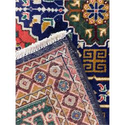 Persian Tabriz indigo ground rug, overall Quba design, decorated with repeating stylised plant motifs and interlaced with trailing leaf motifs, repeating border within geometric guard stripes
