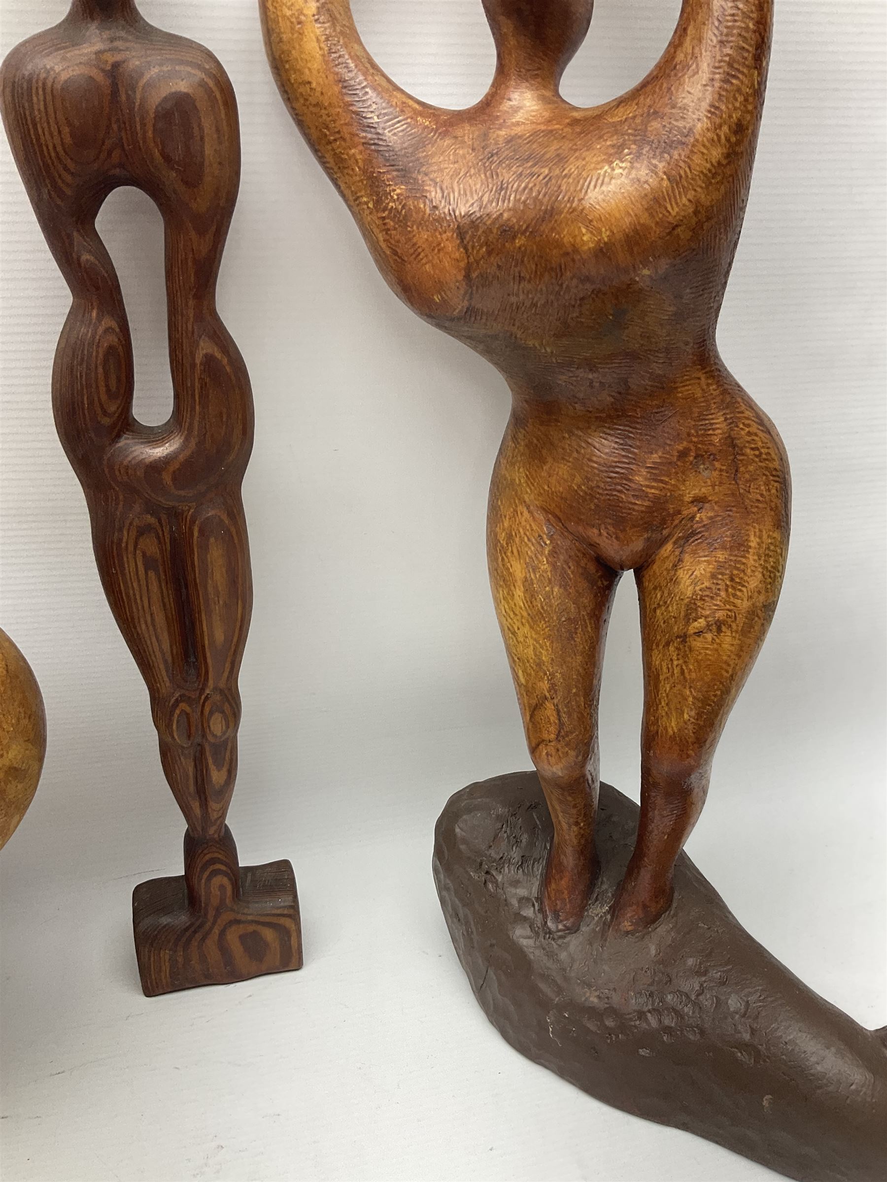 Helen Skelton (British 1933 – 2023): Three carved wooden abstract sculptures, each modelled as a a figure, tallest H52cm. Born into an RAF family in 1933 in Kent and travelled the world extensively during her childhood. After settling in Bridlington, Helen immersed herself in painting, textiles, and wood sculpture, often inspired by nature's beauty. Her talent was showcased in a one-woman show at Sewerby Hall and recognised with the sculpture prize at Ferens Art Gallery in 2000. Sadly, Helen’s daughter passed away from cancer in 2005. This loss inspired Helen to donate her sculptures to Marie Curie upon her passing in 2023.