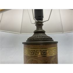 Table lamp of cylindrical form with cast metal mounts and raised upon a trefoil base with fabric shade, H75cm overall