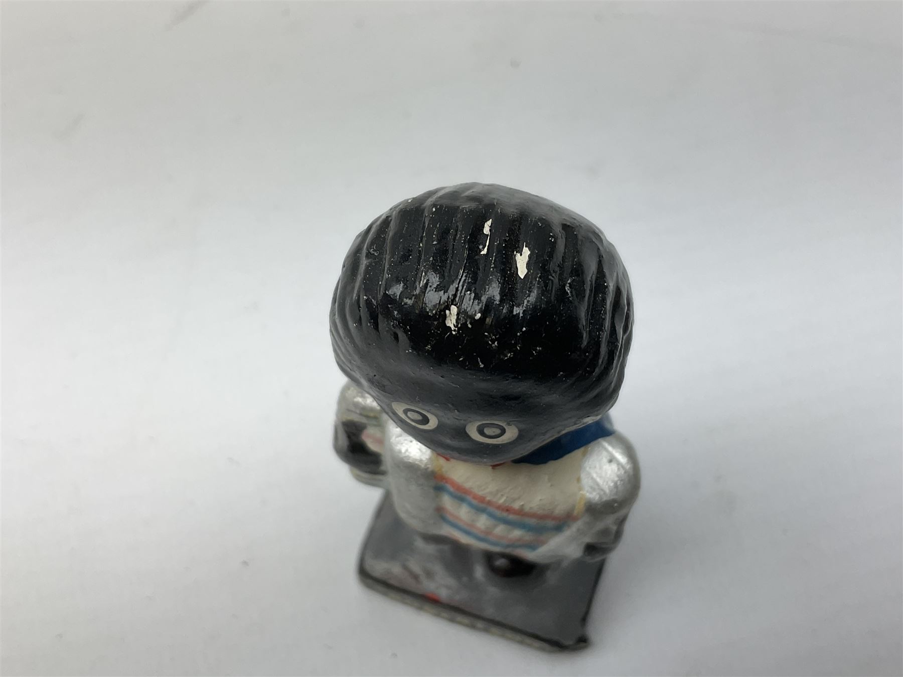 Robinson Jam plaster Golly band, including drummer and singer, H7.5cm

Originally handmade by mothers in Africa for their children from old fabric and cloth, the golly doll was adopted as the mascot and trademark for the Robertson's confectionery brand around 1910 after the company's founder John Robertson visited the US and noticed children playing with them. Robertson's Gollies have been collected by people across the UK and around the world for generations but garnered a contentious image in the 1980s because of links to racism. The trademark was removed from Robertson's branding in 2001.