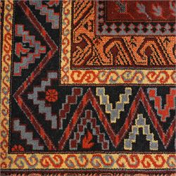 Persian Karabagh design rug, red madder field with three linked octagonal medallions surrounded by floral geometric motifs within multiple stylized borders 