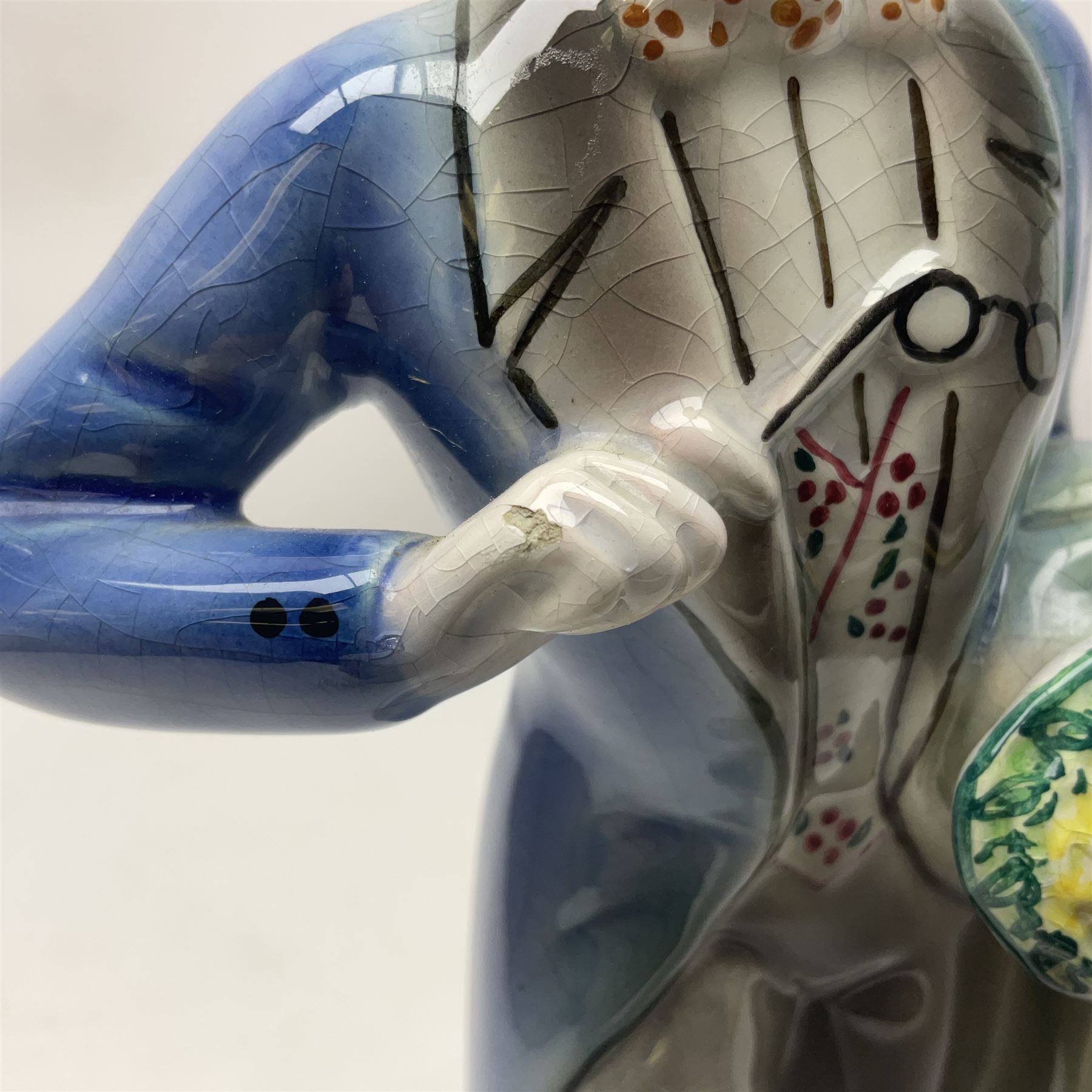 Goldscheider figure, modeled as a gentleman with flowers, upon a circular base, with printed mark beneath, H25cm