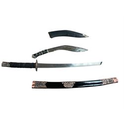Eastern Kukri knife in leather scabbards, together with a reproduction sabre, in a lacquer...