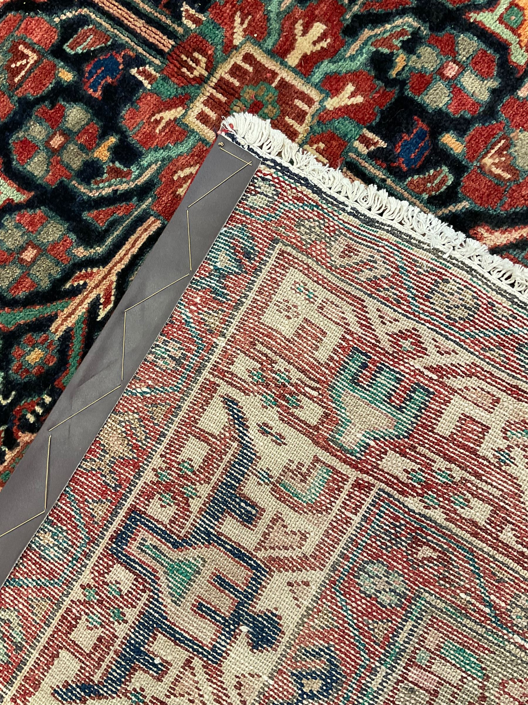 Persian Malayer rug, the field decorated with tree of life, floral, animal and bird motifs, surrounded by three band border with geometric design