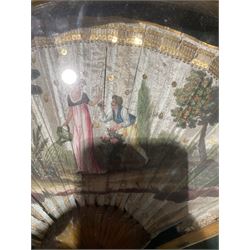 18th century fan, the horn sticks and guard with silvered and gilded decoration, the silk leaf painted in strong colours with a young couple in a garden setting, within a border of gold coloured sequins, framed and glazed, overall H35cm L55cm
Provenance: From the Estate of the late Dowager Lady St Oswald