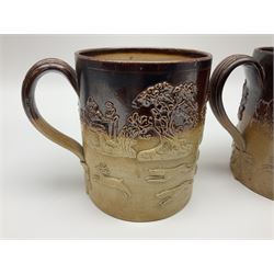 Set of three Victorian  salt-glazed tankards, decorated in relief with hunting scenes within a landscape, H14cm