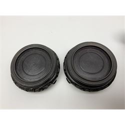 Pair of Chinese cinnabar lacquer vases, each of bulbous baluster form, carved with peonies and foo dogs amongst scrolls, with blue enamel interior and upon wooden bases, H20cm