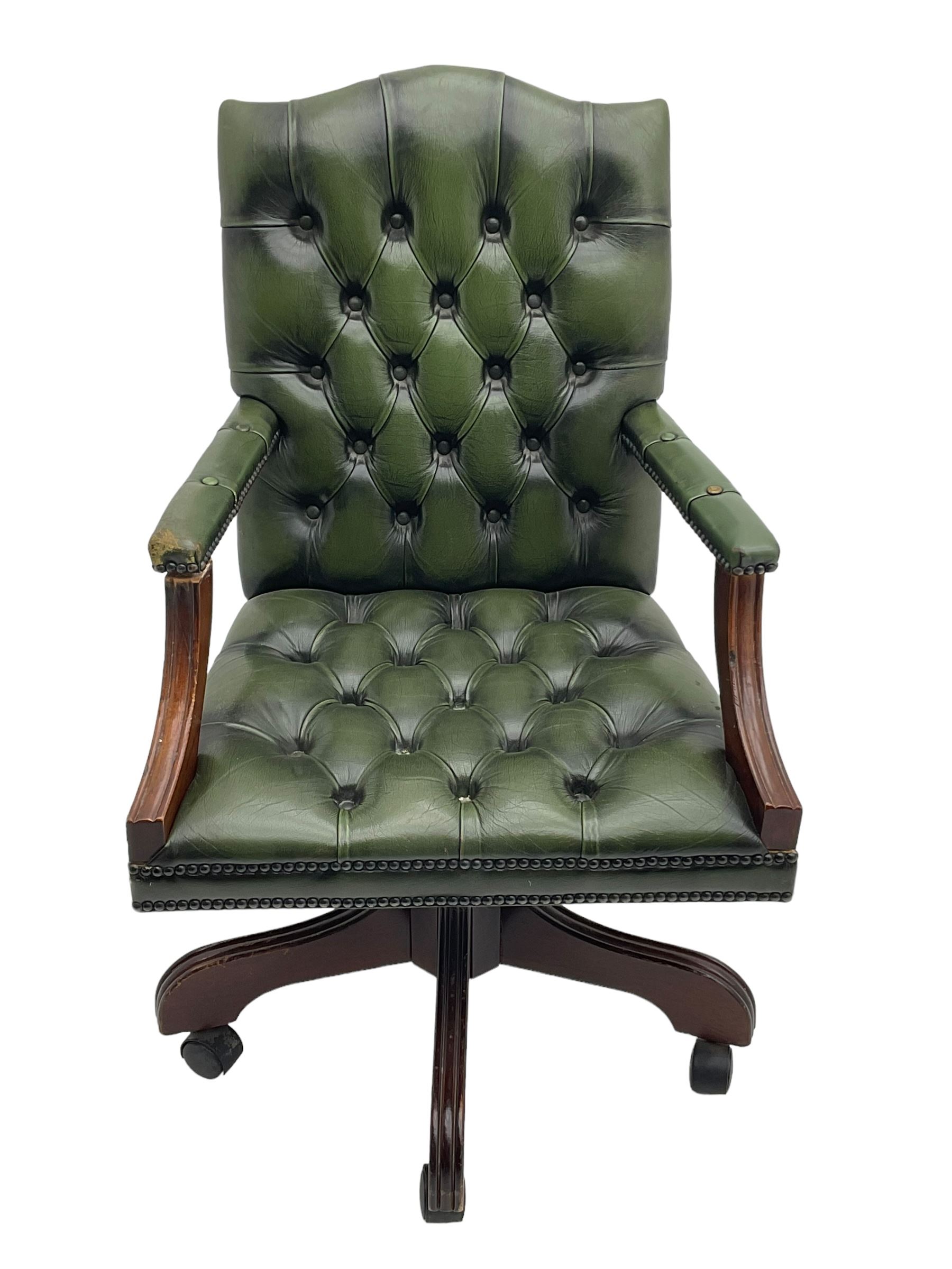 Georgian design swivel office desk chair, upholstered in buttoned green leather, on five spoke base with castors 