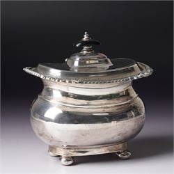Edwardian silver tea caddy with hinged lid, ebonised lift and gadrooned edge on compressed...
