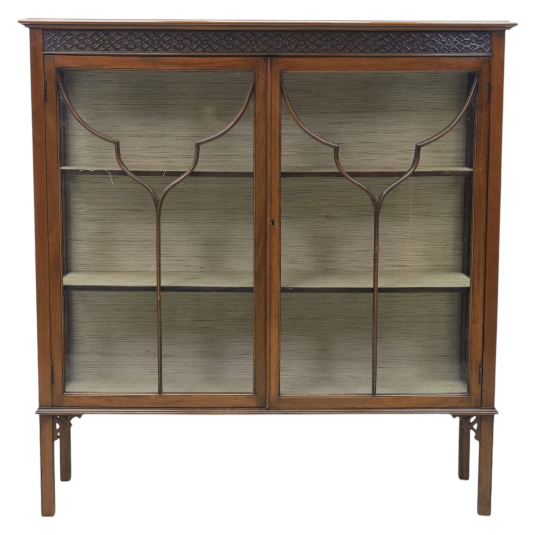 Edwardian mahogany display cabinet, blind-fretwork frieze over astragal glazed doors, square legs with fretwork detail