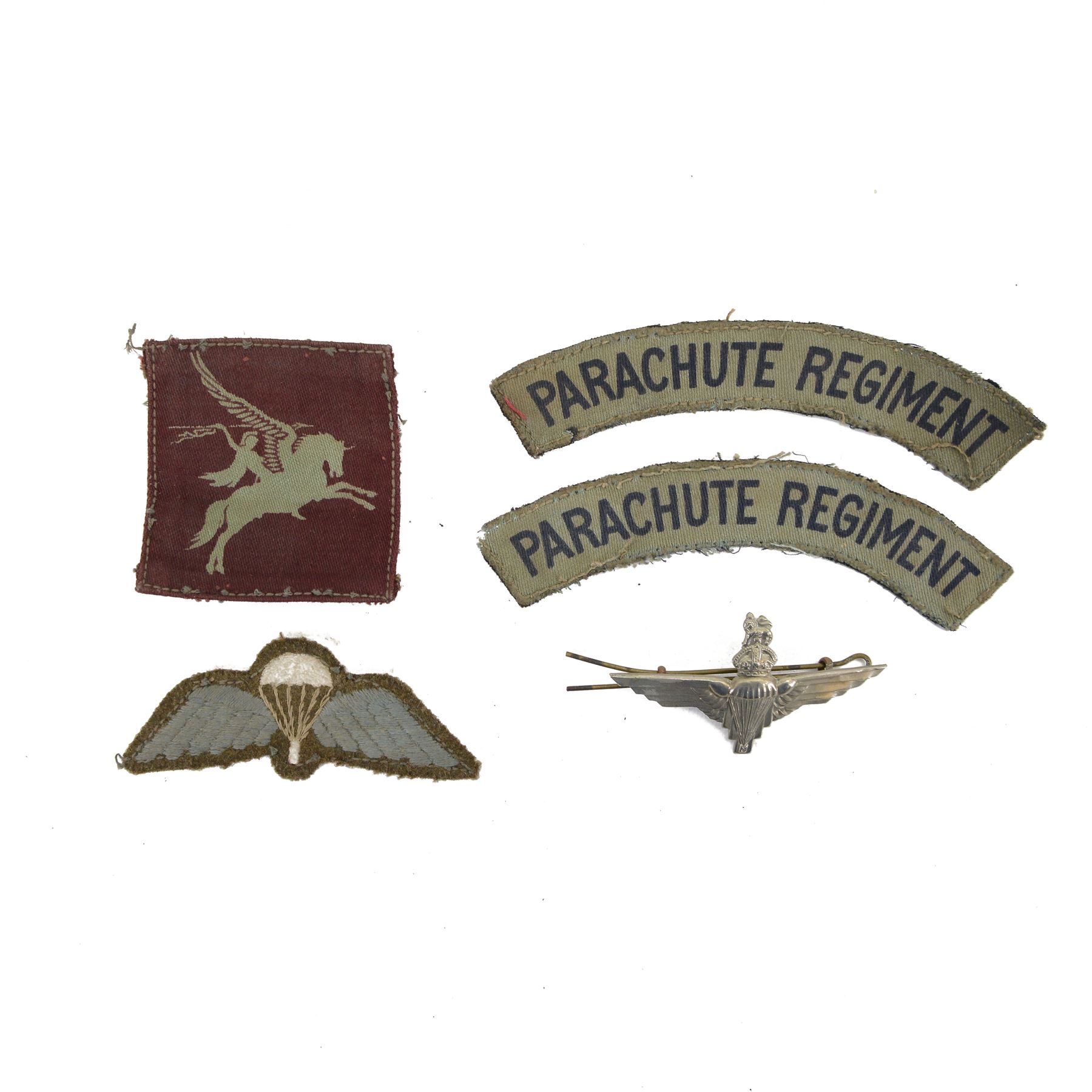 WWII Parachute Regiment insignias, comprising two shoulder titles, Pegasus formation badge, cloth wings and cap badge 