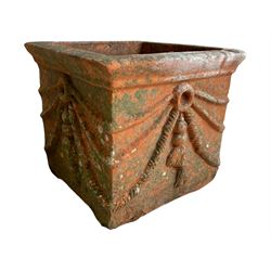 Pair of early 20th century terracotta garden planters, square form with rounded lipped rim, decorated with rope and tassels