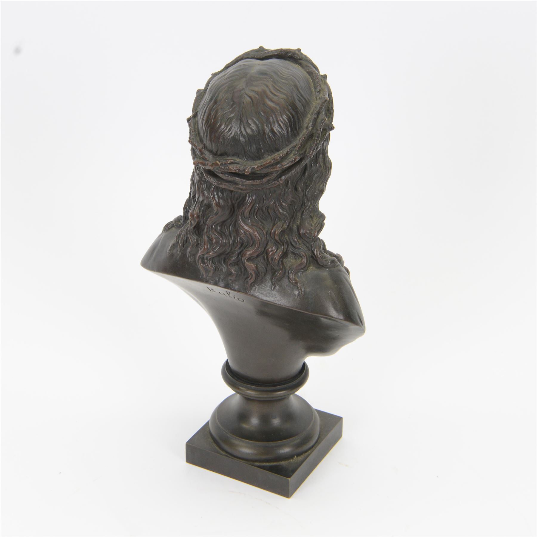 After Jean Bulio (French 1827-1911): bronze bust, modelled as Christ wearing crown of thorns, upon a socle base and square plinth, signed Bulio verso, overall H28.5cm
