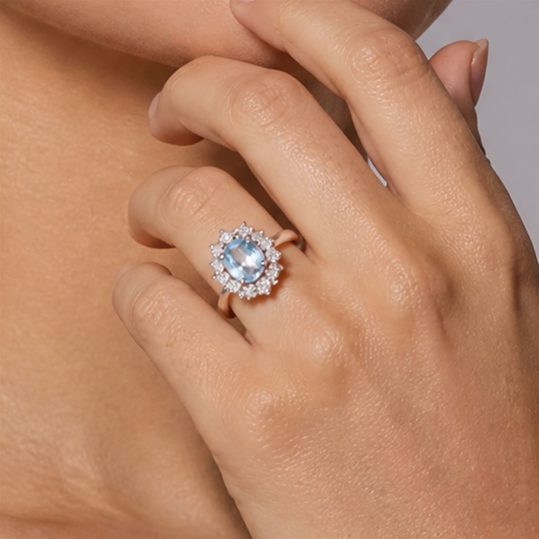 18ct white gold aquamarine and diamond cluster ring, single oval cut aquamarine of approx 0.85 carat, surrounded by twelve round brilliant cut diamonds, hallmarked, total diamond weight approx 0.50 carat