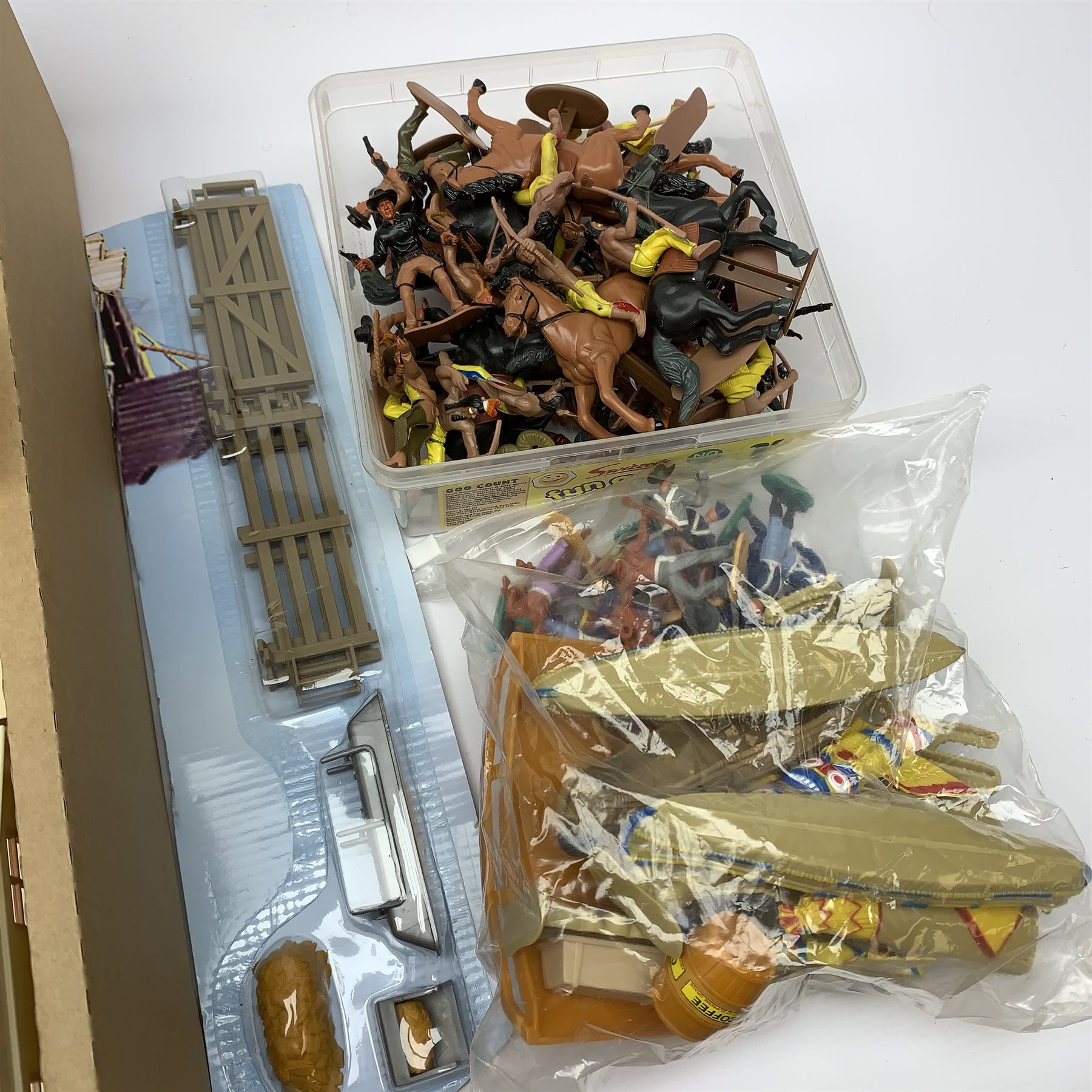 Frontierland play setting with plastic cowboy and Indian figures, totem poles, wig-wams, canoes, various town buildings, covered wagons, stage coaches etc