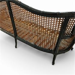 Early 20th century French bergère settee, the shaped caned back flanked by caned sides and scrolling arms, moulded beech frame with dark painted finish, serpentine seat rail with webbing, on cabriole legs with pad feet