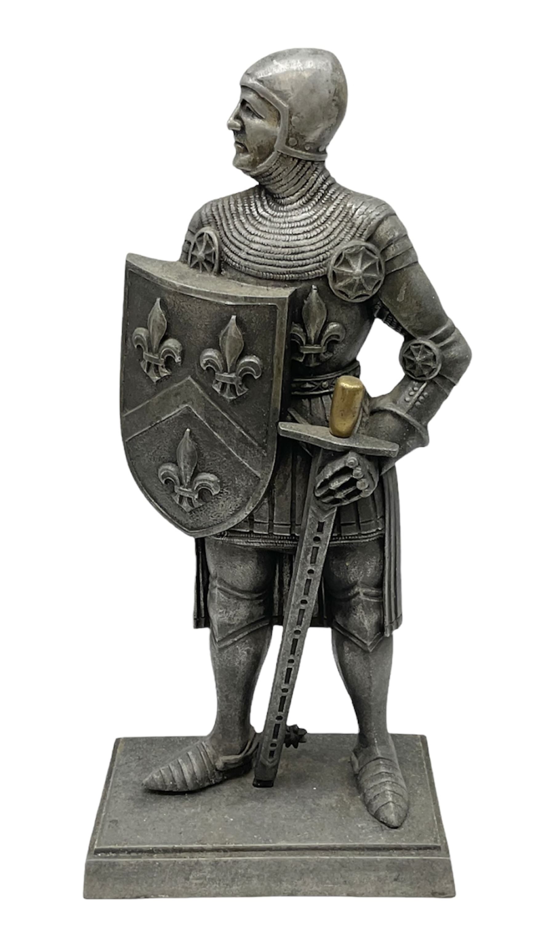 Cast iron fire companion set modelled as a knight in armour with fleur-de-lis shield and sword concealing fire poker, with brass tongs to reverse, raised upon stepped rectangular base, H55cm