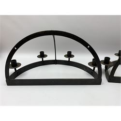 Pair of wrought iron wall mounted candle sconces, of quadrant form with four sockets over drip pans, H23cm W40.5cm D23cm