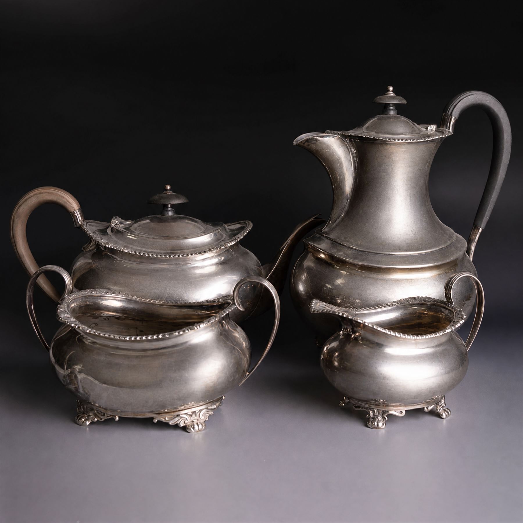 Victorian four piece silver tea service, comprising teapot, hot water pot, open sucrier and cream jug, each of baluster form and decorated with a frieze of neo-classical figures on a textured ground, the teapot and hot water pot with Roman helmet finials and ivory insulated handles, Roberts & Belk, Sheffield 1872, tallest including handle H32cm