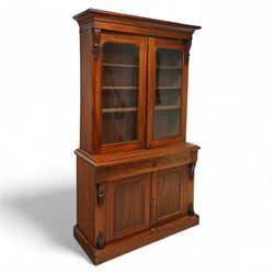 Victorian mahogany two-part bookcase, with integral cornice over arched glazed doors enclo...