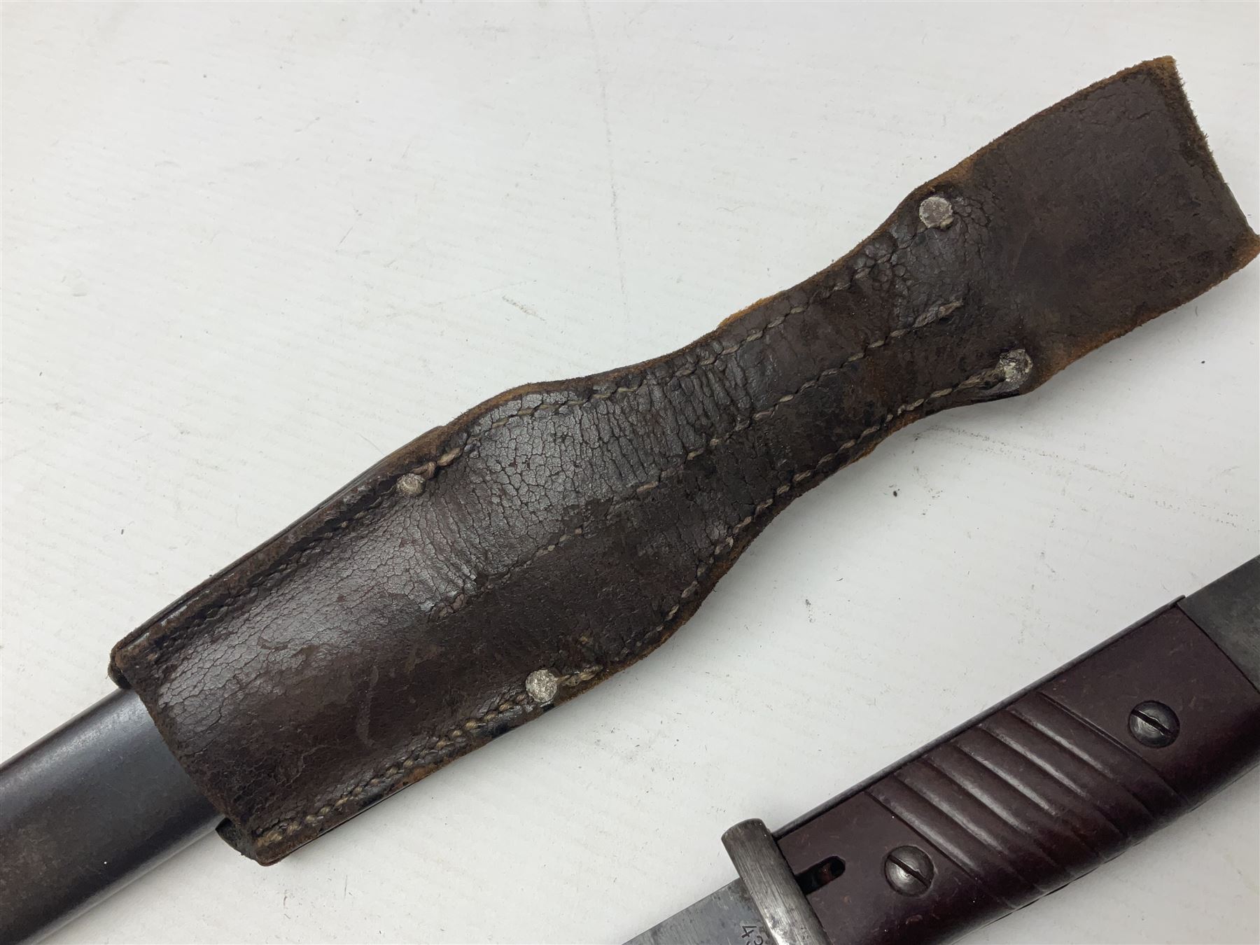 WWII German K98 Mauser bayonet by E. & F. Horster, the 24.5cm fullered blade marked 43aSW for 1943, numerous inspection marks to blade and pommel, bakelite grips and bluing to metal parts; in steel scabbard with corresponding numbers and leather frog L42cm overall