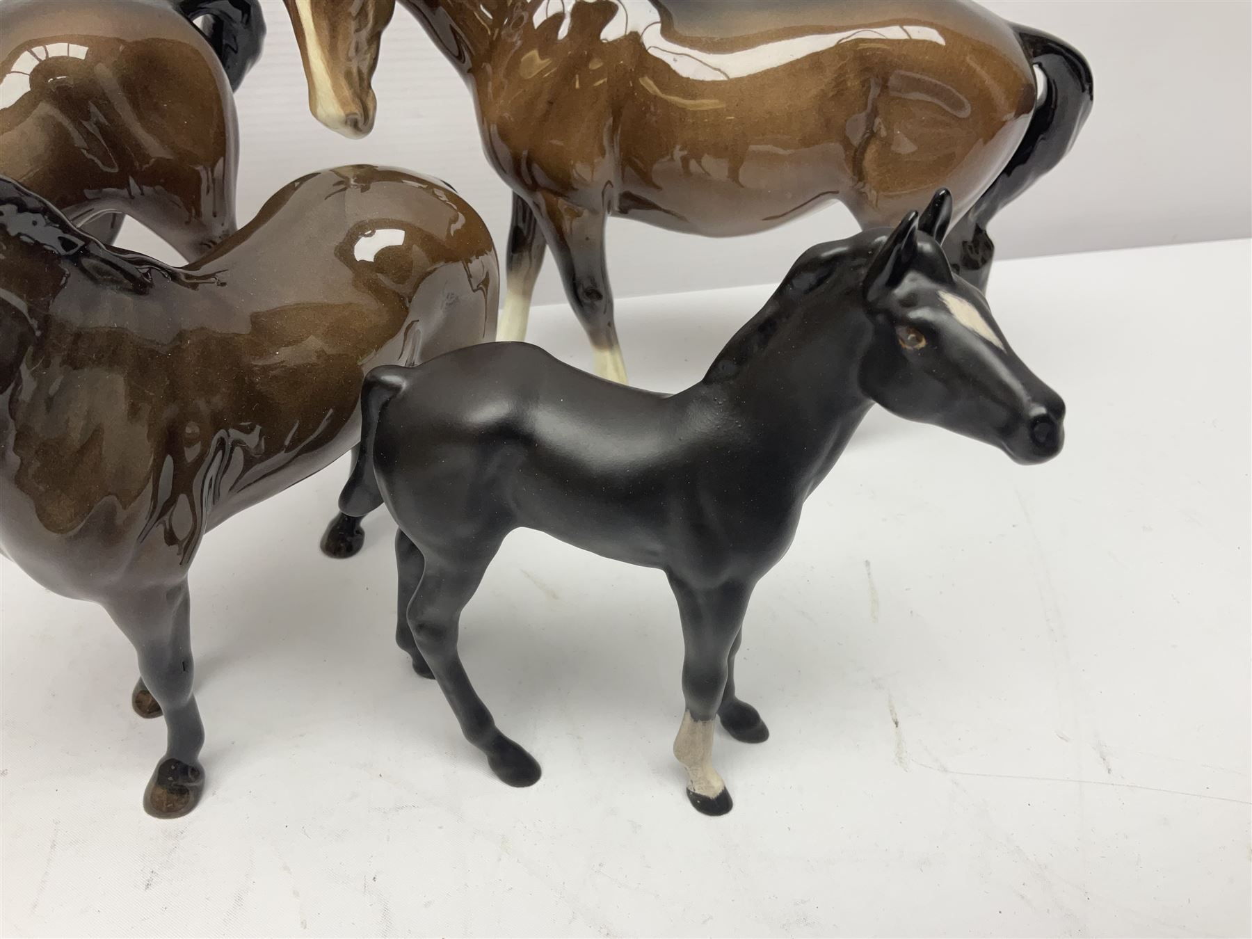 Four Beswick horses, including Exmoor no 1645, Black Beauty foal and two others 