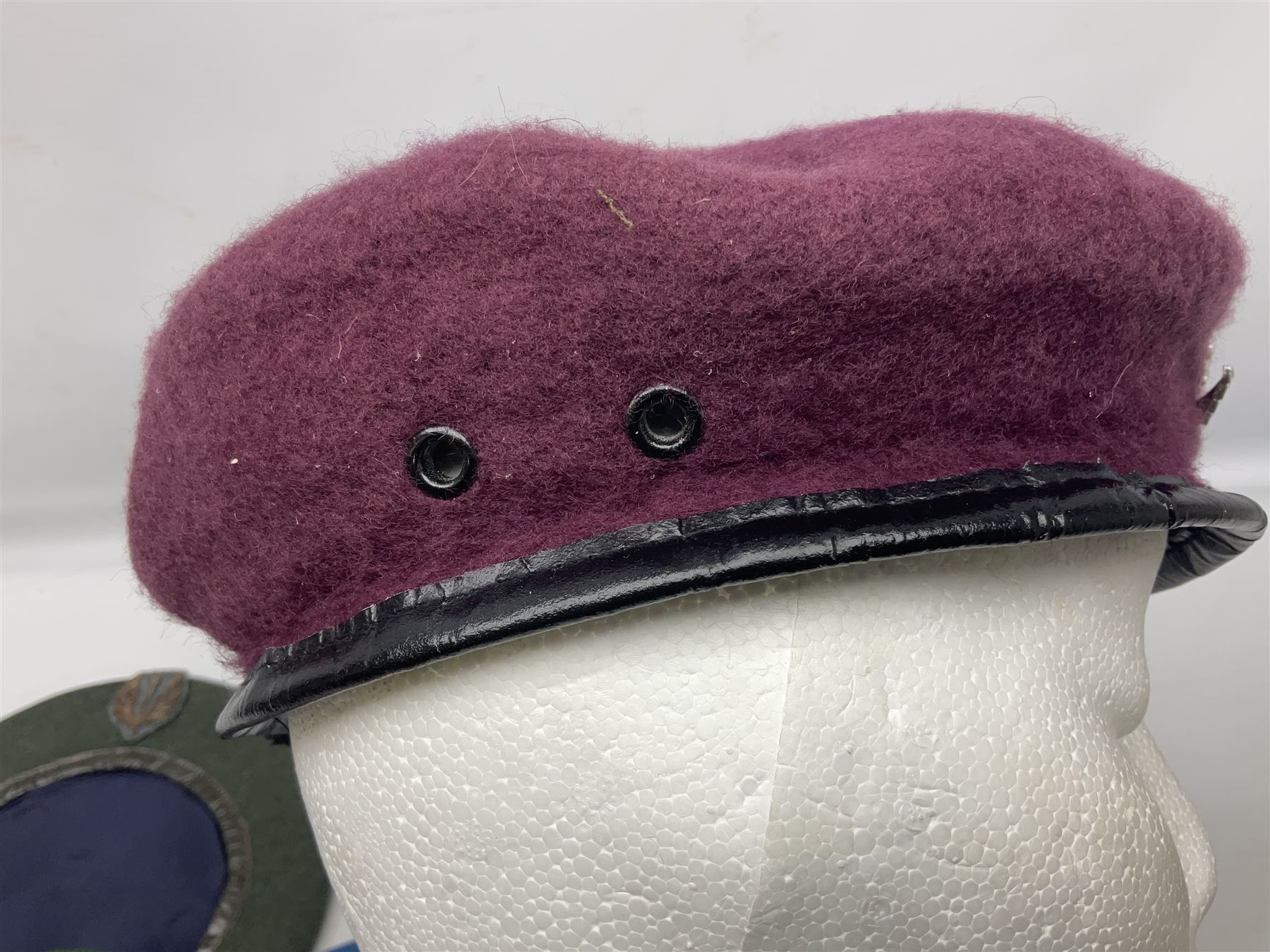 Four paratrooper berets - Russian, Italian, British and Foreign Legion; all with badges (4)