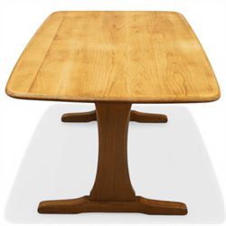 Ercol - mid-20th century golden elm and beech Windsor Range refectory style coffee table, rectangular top with rounded corners raised on end supports with sledge feet