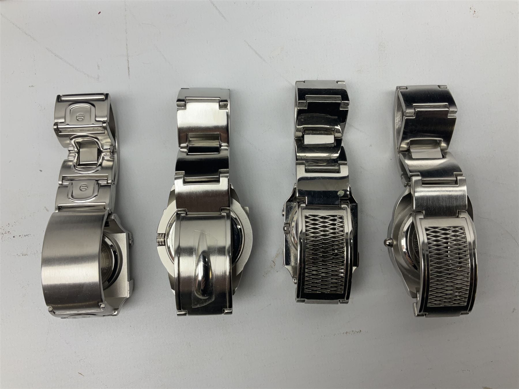 Four X Data stainless steel wristwatches, two Marc Gay wristwatches and one other, all with cover plates