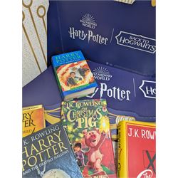 Eleven JK Rowling books, comprising six Harry Potter books, including four first editions, Fantastic Beasts screen play, Harry Potter and the Cursed Child, Tales of Beedle the Bard, Casual Vacancy first edition, Christmas Pig First edition and a Harry Potter card board back drop