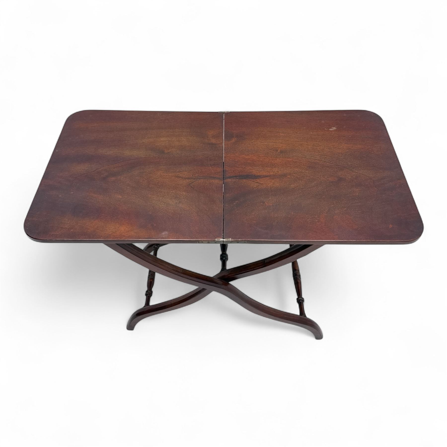 20th century mahogany folding coaching table, hinged rectangular  folding top, divided into two sections, supported on an X-frame with turned stretchers 