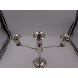 Modern silver mounted three branch candelabra, the tapering stem supporting a central candle holder and two removable curved branches with candle holders, upon spreading circular foot, hallmarked Birmingham 1968, maker's mark worn and indistinct, H25.5cm