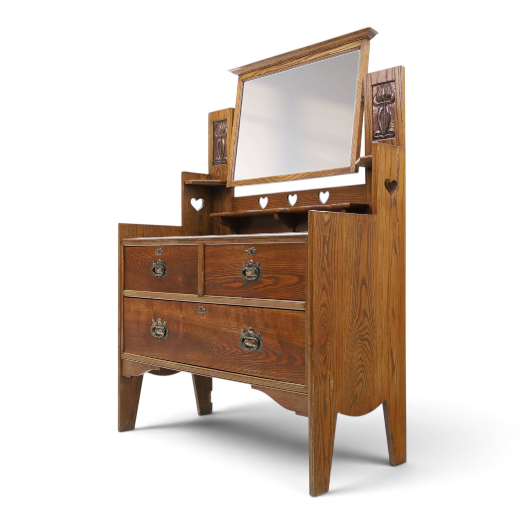 Shapland & Petter - oak mirrored dressing chest, tilted mirror flanked by tulip carved supports, shaped shelves with heart cut outs, above two short over one long drawers, with brass handles and stamped S & P on the locks, raised on shaped supports
