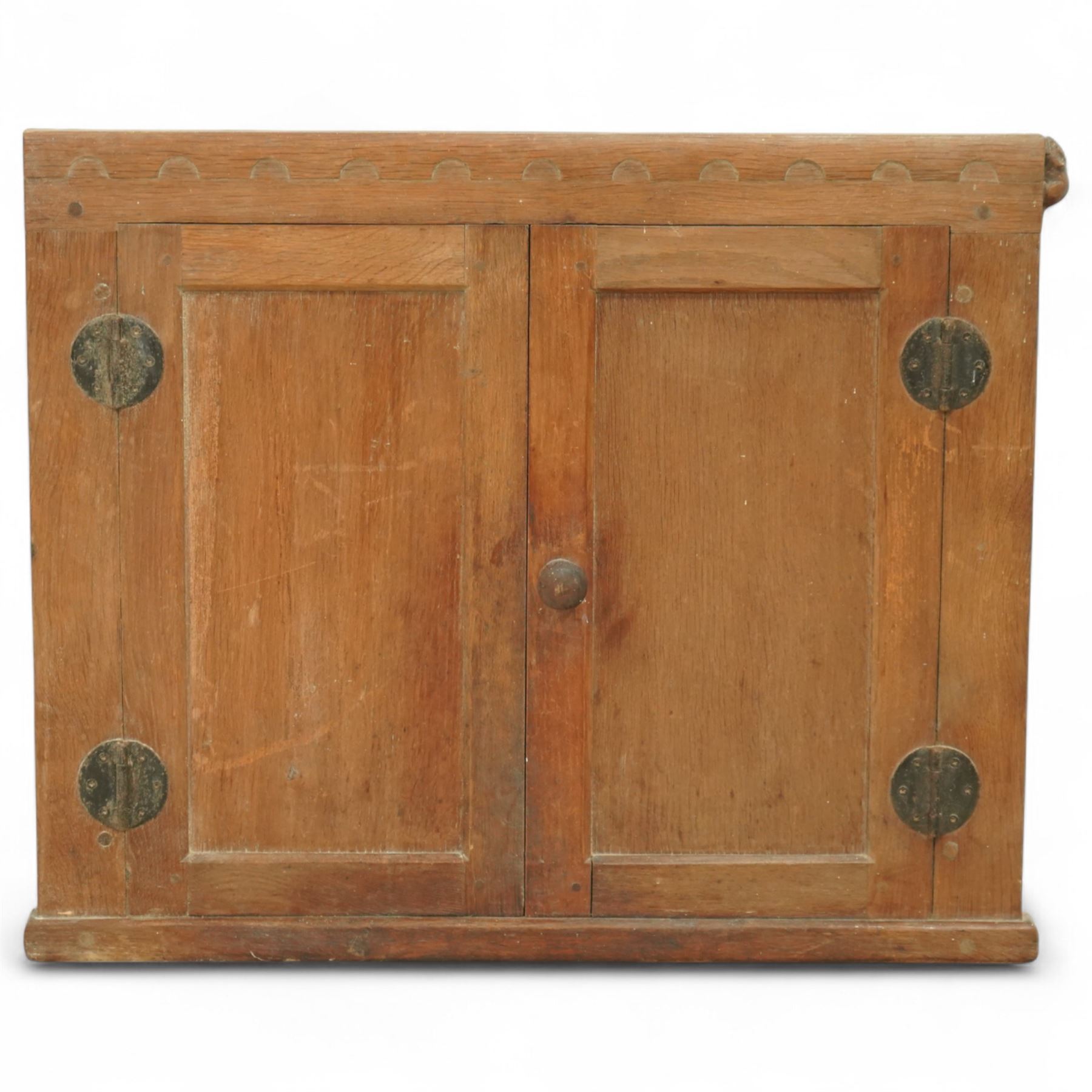 Mouseman - oak cupboard fascia or hatch, of rectangular form with twin panelled doors, circular hinges, raised on plinth, with carved mouse signature, by the workshop of Robert Thompson, Kilburn