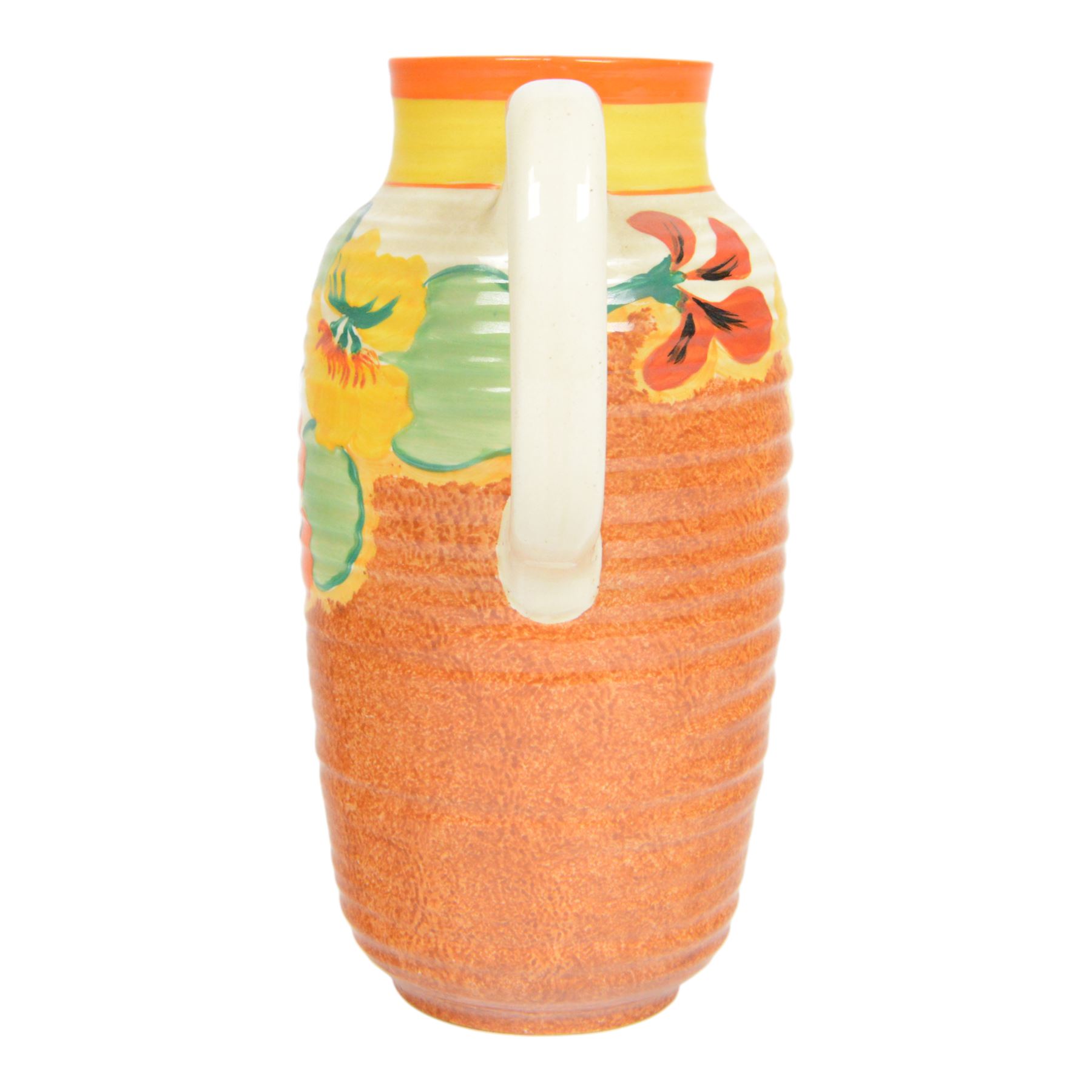 Clarice Cliff Nasturtium jug, shape Greek 563, hand painted with a band of stylised flowers and foliage over a stippled brown ground with orange and yellow banding to the spout,  Bizarre mark beneath, H23cm