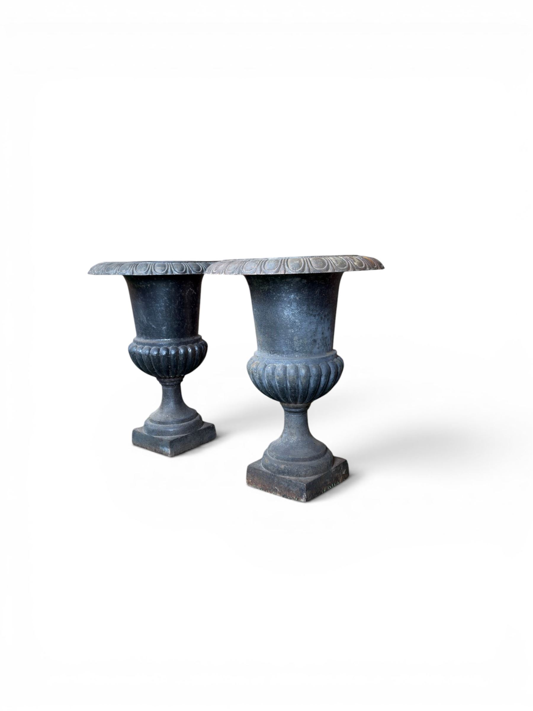 Pair of Victorian design heavy cast iron garden urns, black painted, egg and dart rim on waisted column