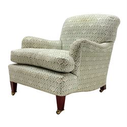 Howard & Sons - Late 20th century armchair, square tapering front supports with brass castors, the rear supports stamped, sprung seats and backs, upholstered in a green and cream foliate patterned fabric

Provenance - Purchased by the vendor from the 
