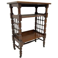 Late 19th century oak three-tier stand or bookcase, on turned supports with lattice sides, on turned feet with castors