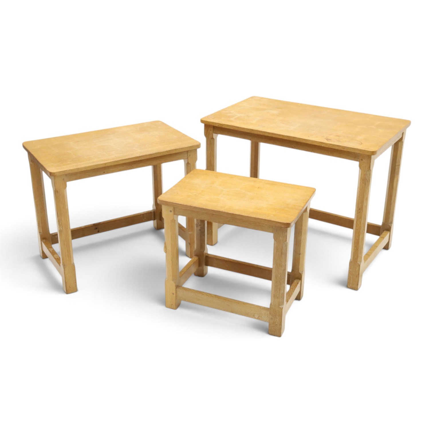 Mouseman - nest of three oak occasional tables, rectangular adzed top, on octagonal supports united by plain stretchers, each carved with mouse signature, by the workshop of Robert Thompson of Kilburn