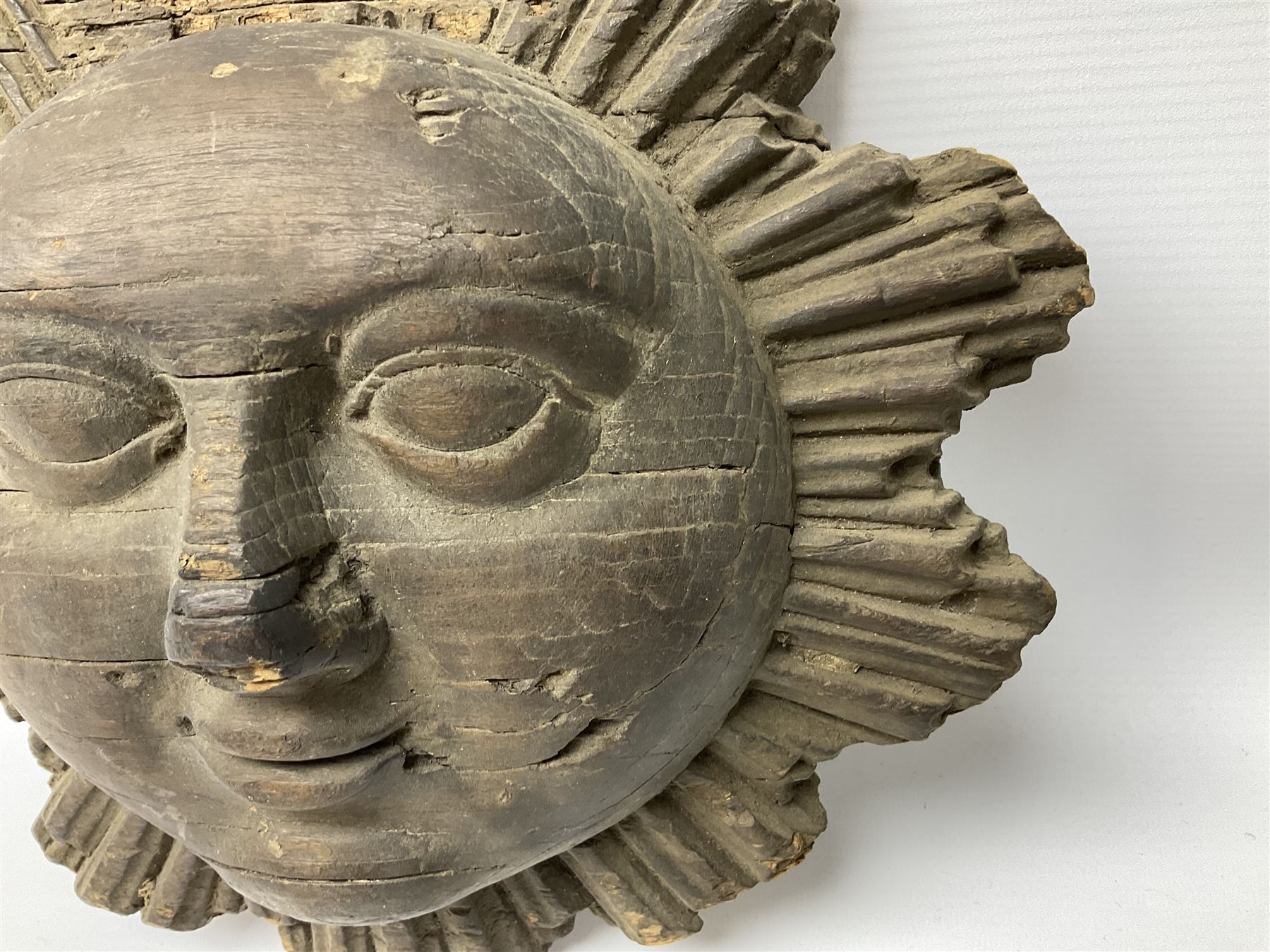 Carved pine mask of the sun, probably late 17th/early 18th century, originally a cresting, bearing Christie's lot labels, D20cm

Provenance 
Lot 161, Christopher Howe - The First Twenty Years, Christie's. 24th March 2004
